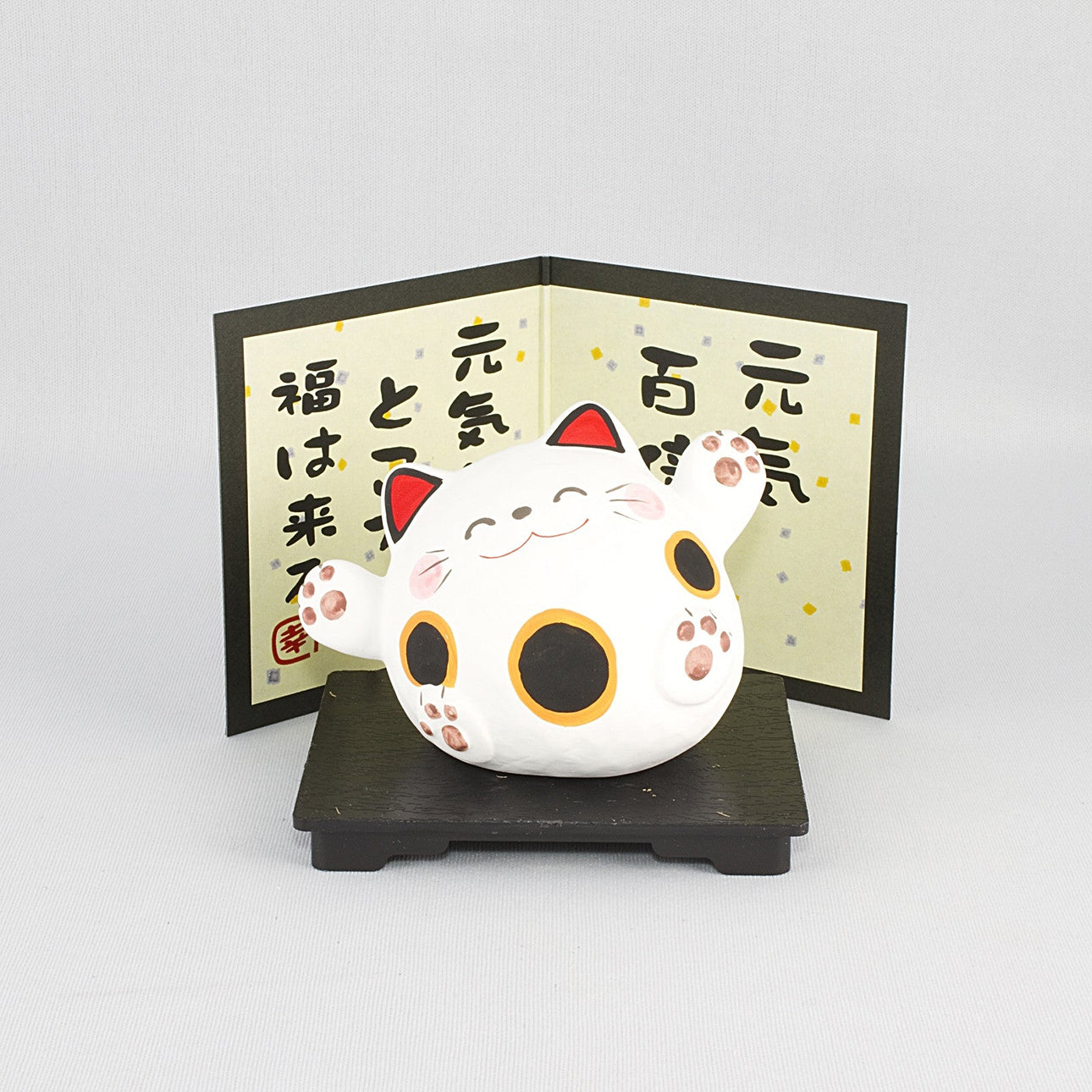 Maneki neko lucky charm in Japanese porcelain