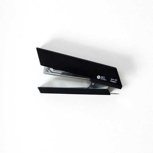 Agrafeuse japonaise noire Yugen lab au design angulaire minimaliste en plastique solide sur fond blanc