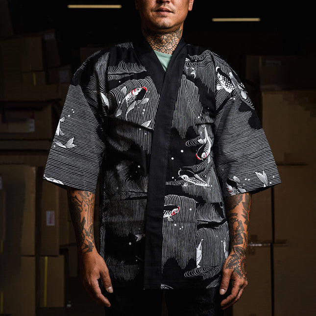 Homme tatoué portant une chemise japonaise happi noire Yugen lab avec un motif de carpes koï blanches et fluides