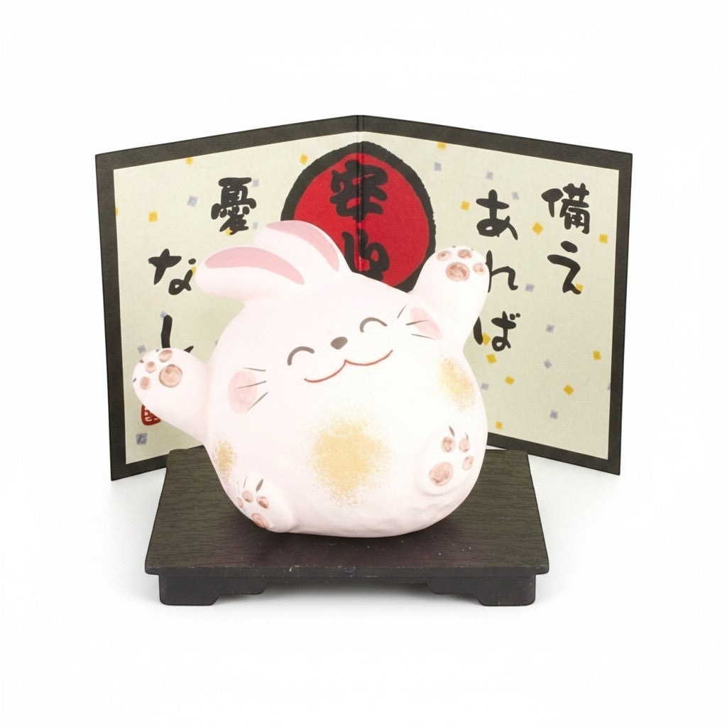 Figurine lapin Yugen lab en céramique rose souriant sur socle en bois avec paravent décoratif japonais
