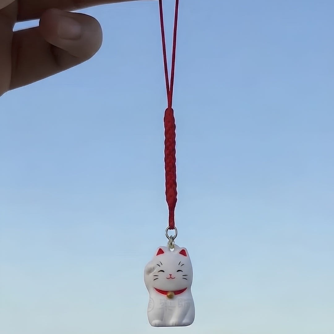 Pendentif Maneki Neko blanc Yugen lab avec cordon rouge tressé et clochette dorée, symbole de chance japonais